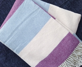 Single blanket in burgundy, cream and gray